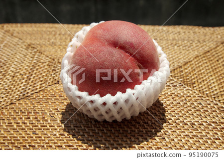Peaches in a fruit cap Peaches in a fruit cap 95190075