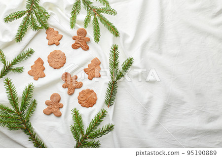 Christmas gingerbread cookies on a textile background. Christmas gingerbread cookies on a textile background. 95190889