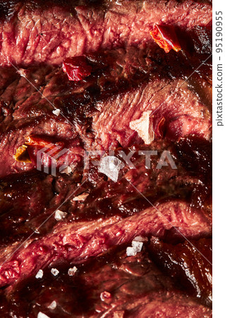 Close up of grilled Medium Rare Ribeye steak with salt cristals Close up of grilled Medium Rare Ribeye steak with salt cristals 95190955