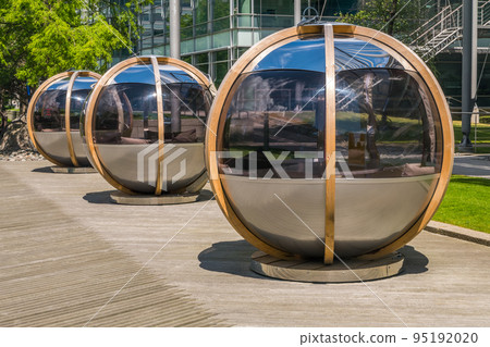 Meeting pods in Chiswick Business Park offer private group discussions for employees amid the relaxing, green park. BSI building in the background. Meeting pods in Chiswick Business Park offer private group discussions for employees amid the relaxing, green park. BSI building in the background. 95192020