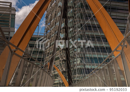 A bridge towards a modern looking building. building and the bridge which are situated in a business park. A bridge towards a modern looking building. building and the bridge which are situated in a business park. 95192033