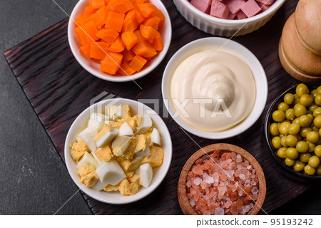 Delicious fresh Olivier salad with sausage, egg, cucumber, green peas, carrots and mayonnaise Delicious fresh Olivier salad with sausage, egg, cucumber, green peas, carrots and mayonnaise 95193242