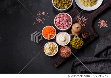 Delicious fresh Olivier salad with sausage, egg, cucumber, green peas, carrots and mayonnaise Delicious fresh Olivier salad with sausage, egg, cucumber, green peas, carrots and mayonnaise 95193247