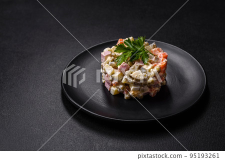 Delicious fresh Olivier salad with sausage, egg, cucumber, green peas, carrots and mayonnaise Delicious fresh Olivier salad with sausage, egg, cucumber, green peas, carrots and mayonnaise 95193261