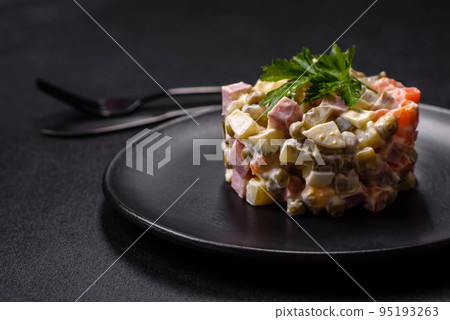 Delicious fresh Olivier salad with sausage, egg, cucumber, green peas, carrots and mayonnaise Delicious fresh Olivier salad with sausage, egg, cucumber, green peas, carrots and mayonnaise 95193263