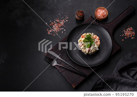 Delicious fresh Olivier salad with sausage, egg, cucumber, green peas, carrots and mayonnaise Delicious fresh Olivier salad with sausage, egg, cucumber, green peas, carrots and mayonnaise 95193270
