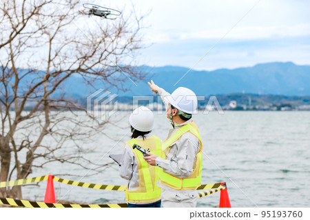 Workers operating drones 95193760