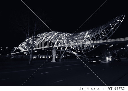 Bridge of Peace over Kura River with neon illuminated at night. Tbilisi, Georgia. Black and white. Bridge of Peace over Kura River with neon illuminated at night. Tbilisi, Georgia. Black and white. 95193782