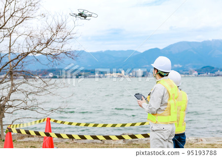 Workers operating drones Workers operating drones 95193788