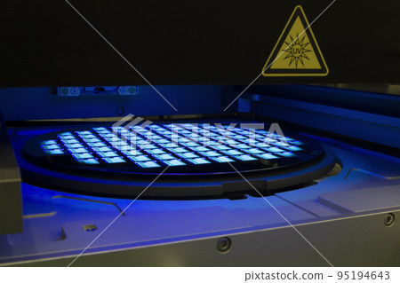 Silicon wafer with chips in UV lighting. Neon. Ultraviolet Lithography. 95194643