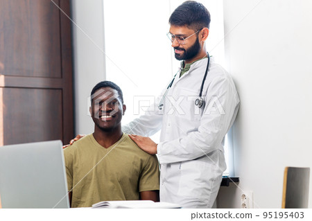 Friendly doctor hands holding patient hand support and hope concept Friendly doctor hands holding patient hand support and hope concept 95195403