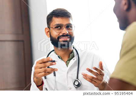 doctor and male patient talking at office consultation for further treatment doctor and male patient talking at office consultation for further treatment 95195404
