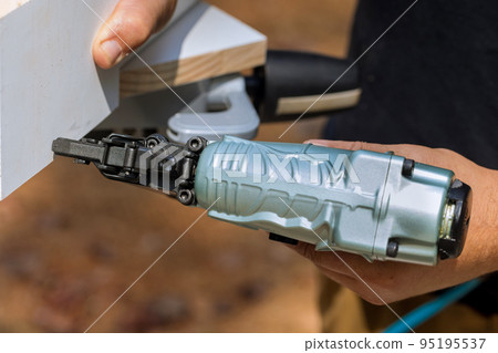 Assembly for wood boards is connected with nails using pneumatic air gun by carpenter Assembly for wood boards is connected with nails using pneumatic air gun by carpenter 95195537