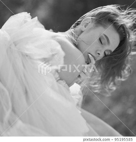 Sexy blonde in a chic classic dress posing in nature. Sexy blonde in a chic classic dress posing in nature. 95195585