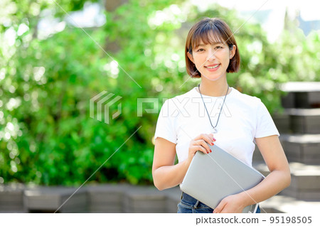 A woman looking at the camera Business computer 95198505