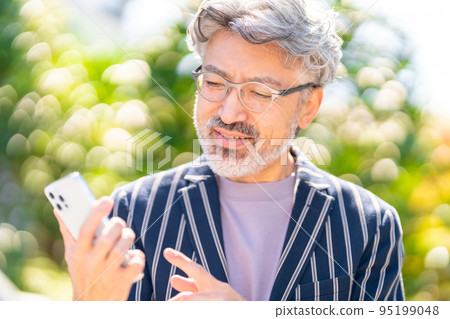 Cool businessman British gentleman elegant appearance cell phone smartphone green ball bokeh 95199048