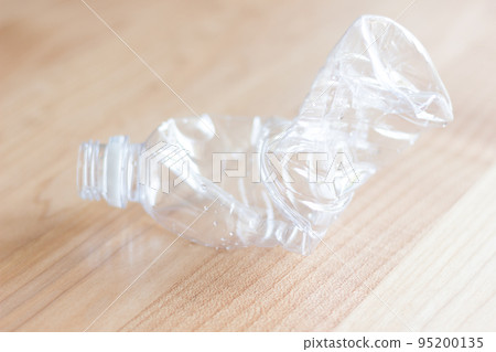A crushed plastic bottle on the table A crushed plastic bottle on the table 95200135
