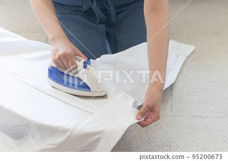 woman ironing a shirt woman ironing a shirt 95200673