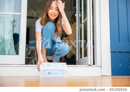 Close up hands of sick Asian woman sitting at door to receive medication first aid pharmacy box 95200938