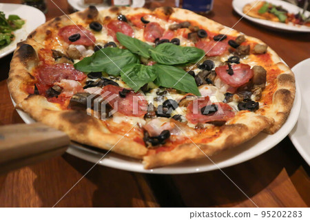 pizza or salami , olive and cheese pizza with vegetable 95202283