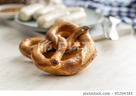Baked bavarian pretzels on white table. 95204385