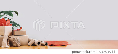 Delivery and gift. Buff paper wrapping, eco pack, parcel on desk. hand craft, handmade small business working from home concept. Shipping and holiday packing 95204911