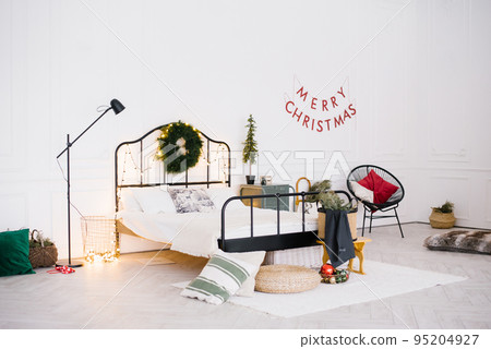 White stylish cozy scandinavian bedroom. New year winter home interior decor. Christmas holiday decorations White stylish cozy scandinavian bedroom. New year winter home interior decor. Christmas holiday decorations 95204927