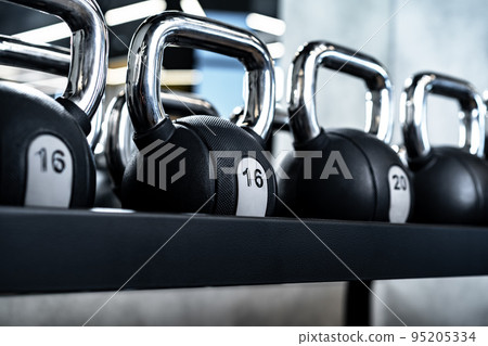 Close up of new dumbbells on a rack in a gym Close up of new dumbbells on a rack in a gym 95205334