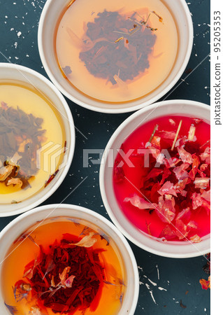 herbal tea in cups on a wooden background herbal tea in cups on a wooden background 95205353