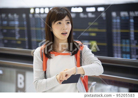 Airport woman with a troubled expression Airport woman with a troubled expression 95205583
