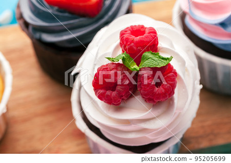 Side view of yummy cupcakes with assorted flavor. Shot on the table Side view of yummy cupcakes with assorted flavor. Shot on the table 95205699