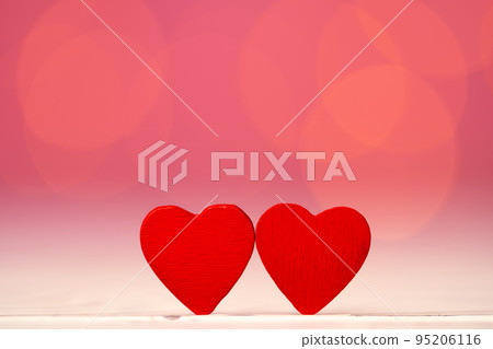 Red heart decoration against pink bokeh background 95206116