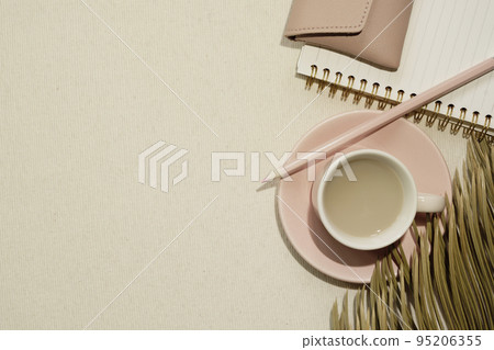 Pink supplies. Cup of coffee and notebook, colored pencil, pouch on beige fabric background. flat lay, top view, copy space Pink supplies. Cup of coffee and notebook, colored pencil, pouch on beige fabric background. flat lay, top view, copy space 95206355