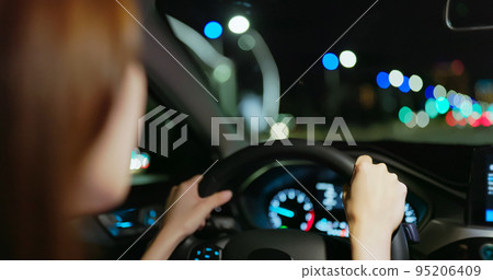 woman is driving at night 95206409