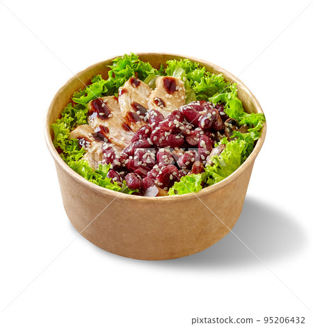 Salad with lettuce, chicken fillet, baked mushrooms and red beans with teriyaki sauce and sesame in paper bowl on white 95206432