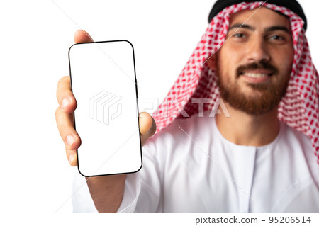 Young Arab muslim man in traditional clothes showing mobile phone isolated on a white background 95206514