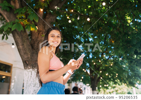 Photo of charming pretty young lady communicating modern gadget Photo of charming pretty young lady communicating modern gadget 95206535