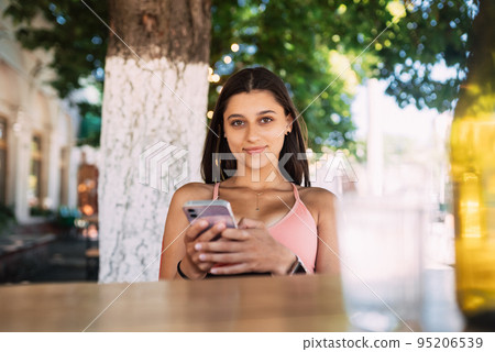 Photo of charming pretty young lady communicating modern gadget Photo of charming pretty young lady communicating modern gadget 95206539