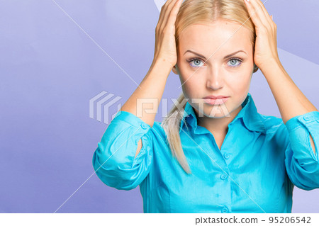A woman with a pain in her head holds on to her head a migraine A woman with a pain in her head holds on to her head a migraine 95206542