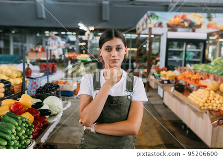 Woman seller of fruit at the market near the counter 95206600