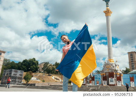 Young woman with national flag of Ukraine on the street 95206753