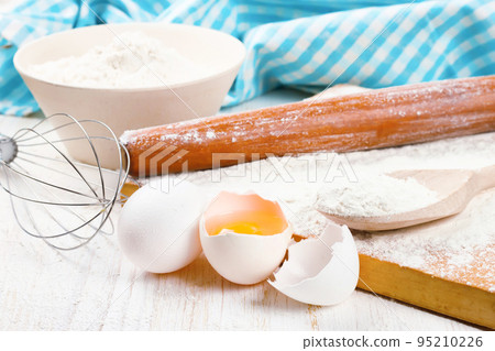 Baking ingredients on white wooden background 95210226