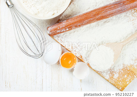Baking ingredients on white wooden background 95210227