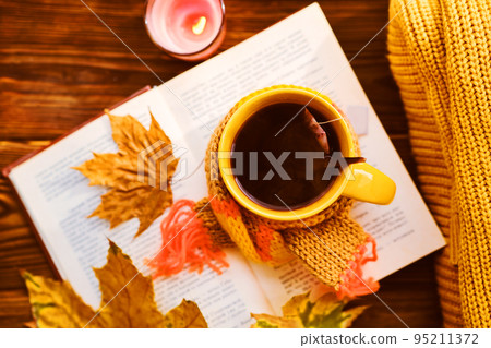 A cup of hot tea with a scarf, books A cup of hot tea with a scarf, books 95211372