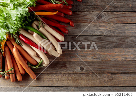 Various sausages with salad, rosemary, and hot peppers. Various sausages with salad, rosemary, and hot peppers. 95211465