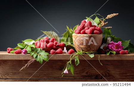Fresh juicy raspberries in wooden bowl. 95211494