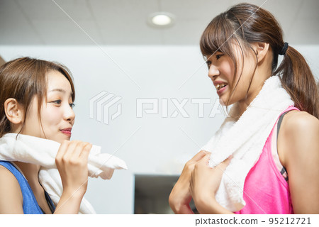 Young woman preparing in gym gym locker 95212721