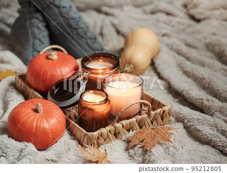 A girl in a sweater and knitted socks sits on a blanket A girl in a sweater and knitted socks sits on a blanket 95212805