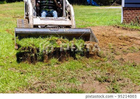 Using bulldozer for landscaping works, scoop to move earth around Using bulldozer for landscaping works, scoop to move earth around 95214003