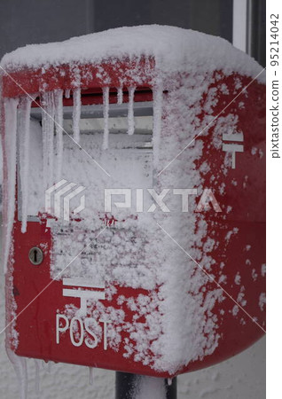 Icicles and red mailbox 1 on a snowy hat 95214042